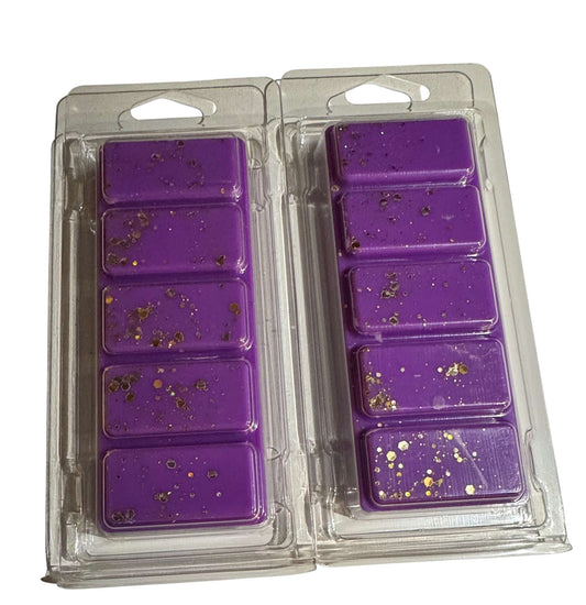 A clear plastic package containing purple wax tarts with gold glitter. The package is designed for snapbars and wax melts.