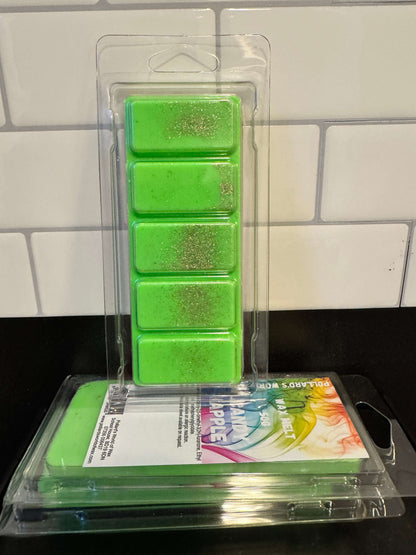 Green wax melts in packaging on a tiled surface