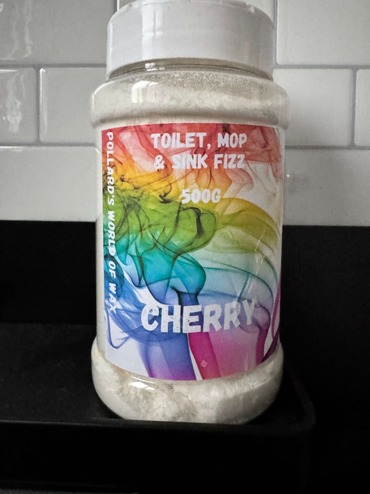 A bottle of Cherry Toilet, Mop & Sink fizz, 500g size, with a multicolored label.